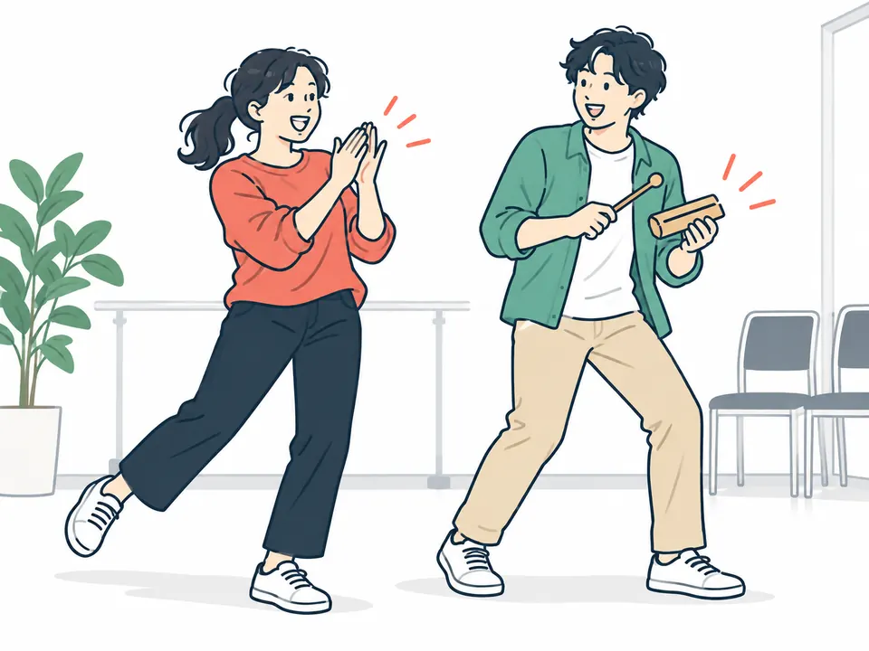 手拍子をする女性と、ウッドブロックを打ちながら踊る男性