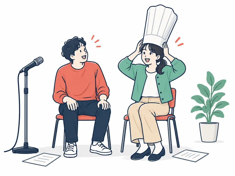 椅子に座ったまま、コック帽をかぶって笑い合う男女