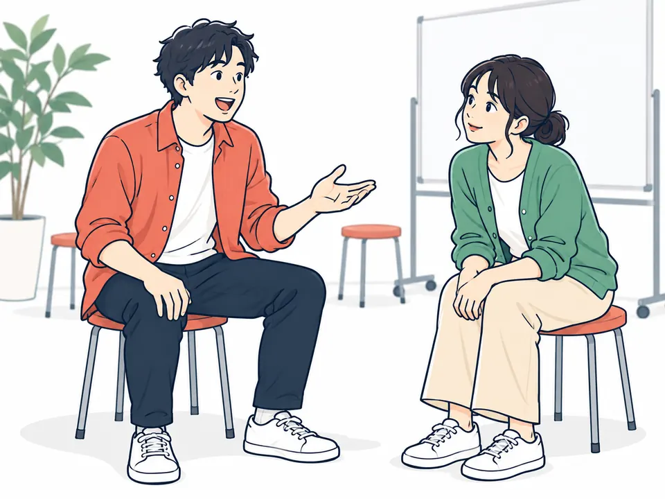 いすに座り、相手の話を最後まで聞いてから返す2人
